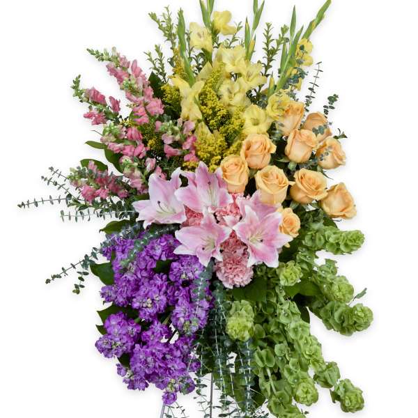 Tall standing floral spray with pink, yellow, peach, purple, and green blooms