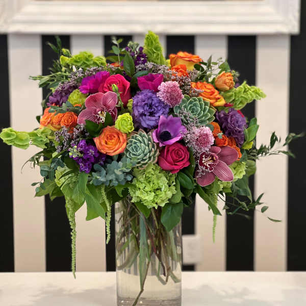 Colorful mixed flower arrangement in a clear glass vase