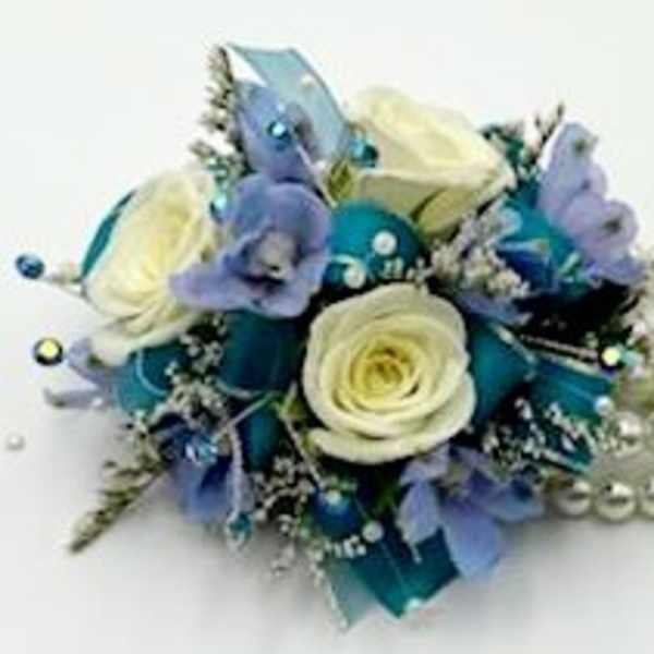 Blue and white floral corsage with pearl accents