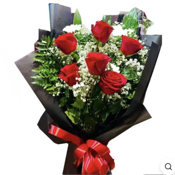 Bouquet of red roses with white filler flowers wrapped in black paper