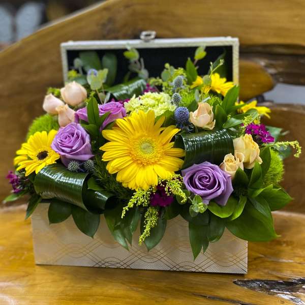 Mixed bouquet in a decorative box with yellow daisies and purple roses