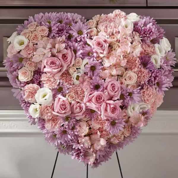 Heart-shaped floral arrangement with pink and lavender flowers