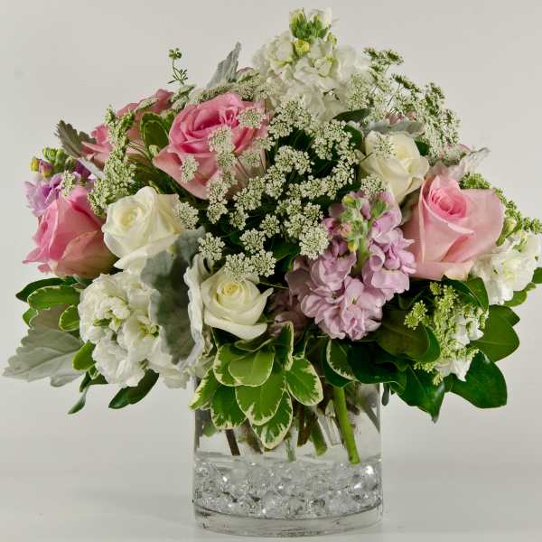 Pink and white roses in a clear glass vase