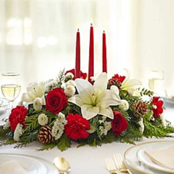 Red and white floral centerpiece with three red candles
