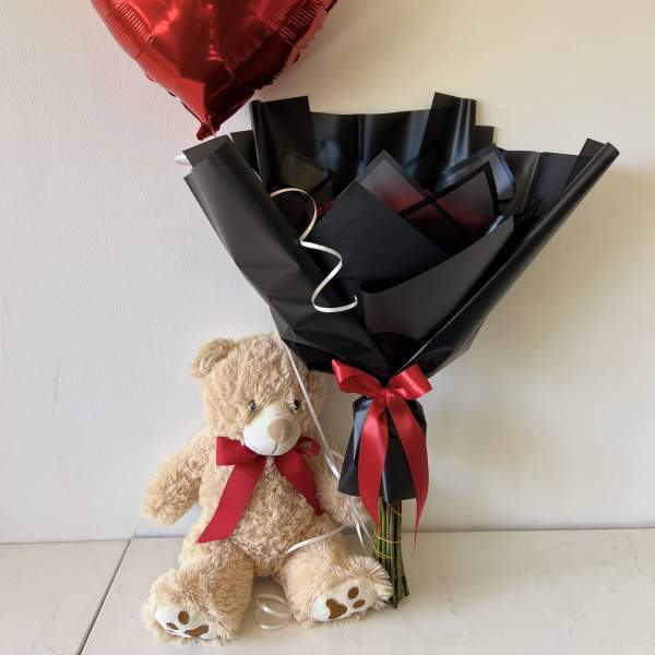Red heart balloon with teddy bear and wrapped bouquet