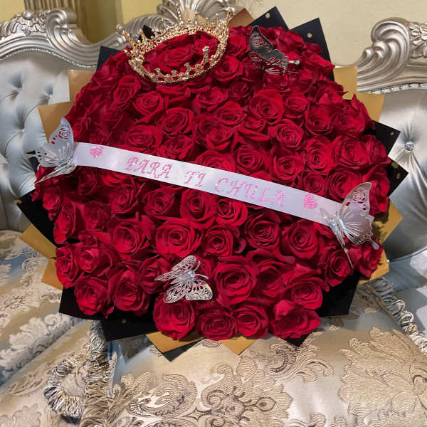 Large bouquet of red roses with a tiara and butterfly decorations
