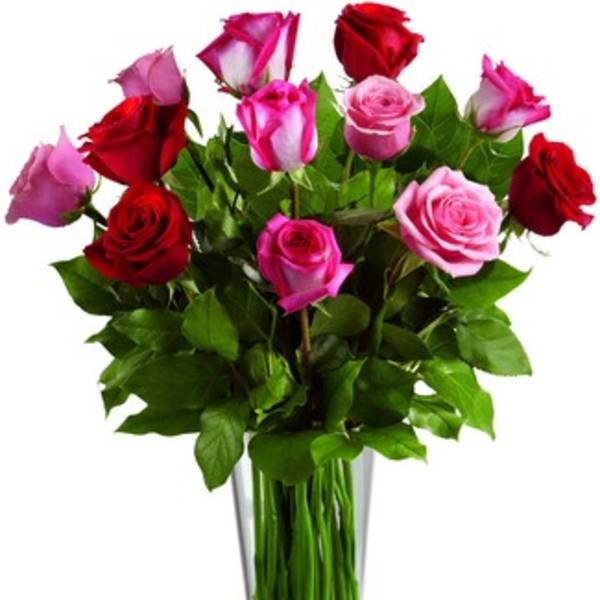 Bouquet of red and pink roses in a clear glass vase