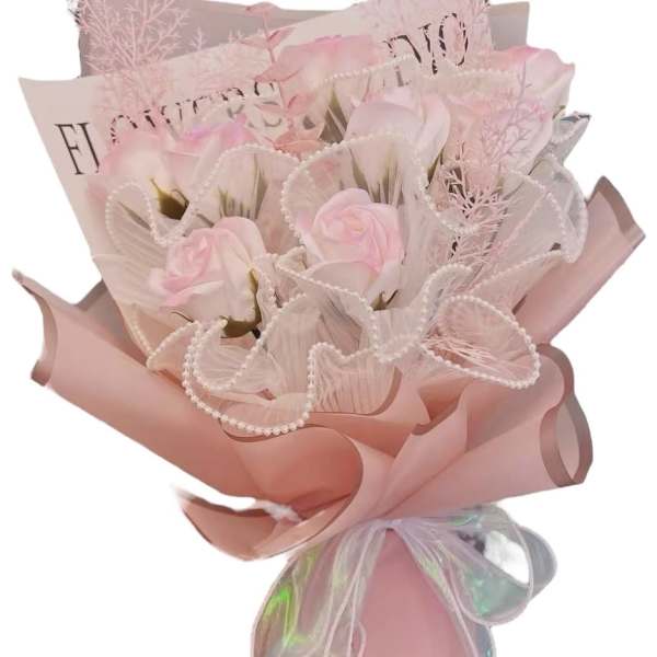 Pink bouquet of roses wrapped in pastel paper with a ribbon