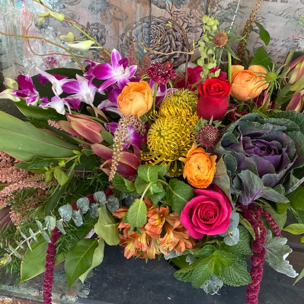 Colorful mixed bouquet with orchids, roses, and chrysanthemums