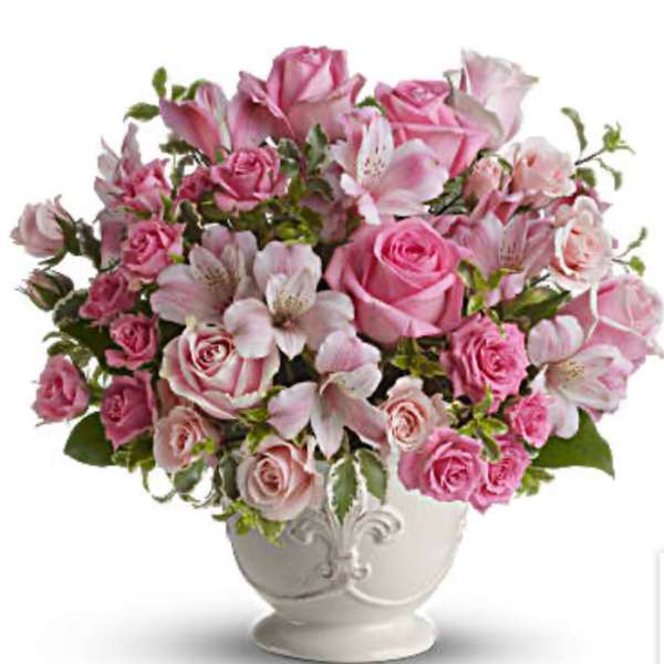Pink roses and alstroemeria arranged in a white vase