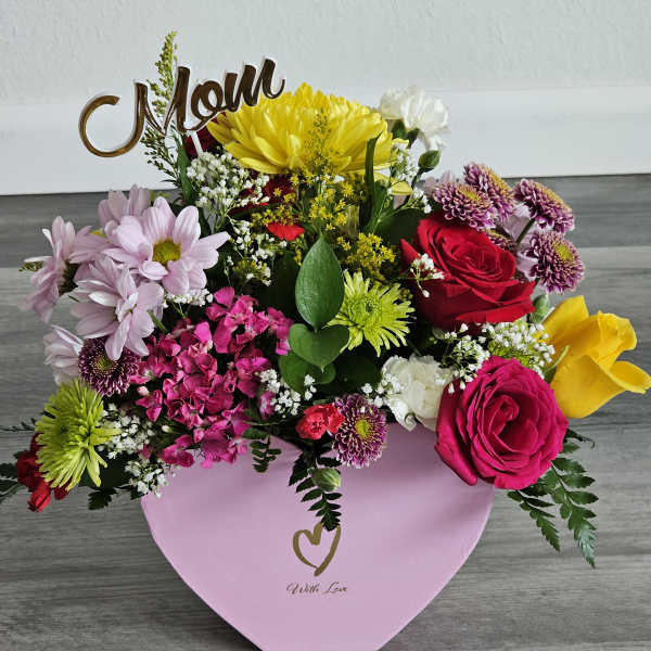 Mixed bouquet in a pink heart box with a "Mom" topper