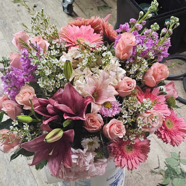 Bouquet of pink and purple flowers in a container