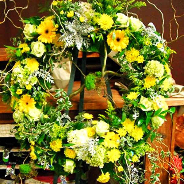 Large floral wreath with yellow and white flowers