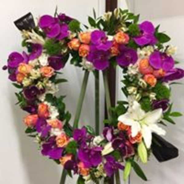 Heart-shaped floral wreath with purple, orange, and white blooms
