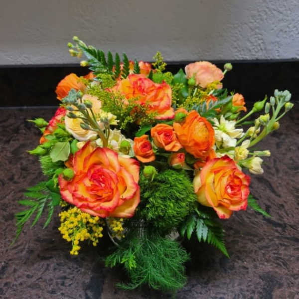 Bouquet of orange and yellow roses with green filler