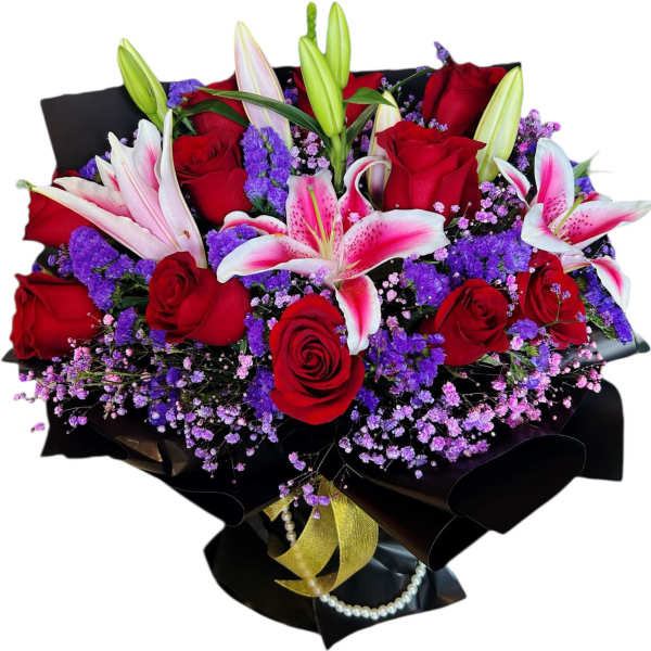 Bouquet of red roses and pink lilies wrapped in black paper