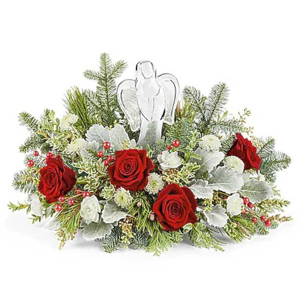Red roses and white flowers arranged with an angel figurine