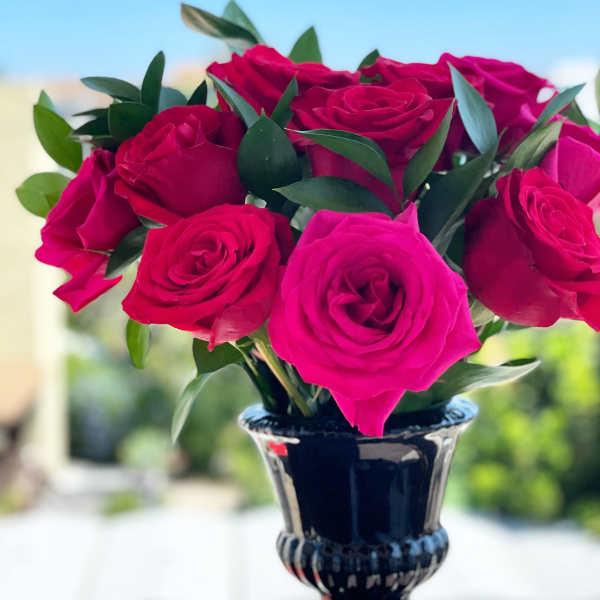 Bouquet of hot pink roses in a dark vase