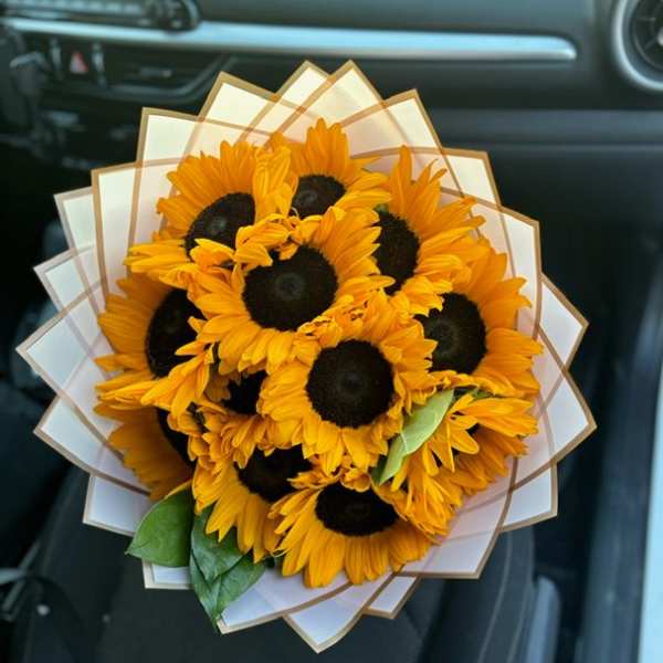 Bouquet of sunflowers wrapped in white paper