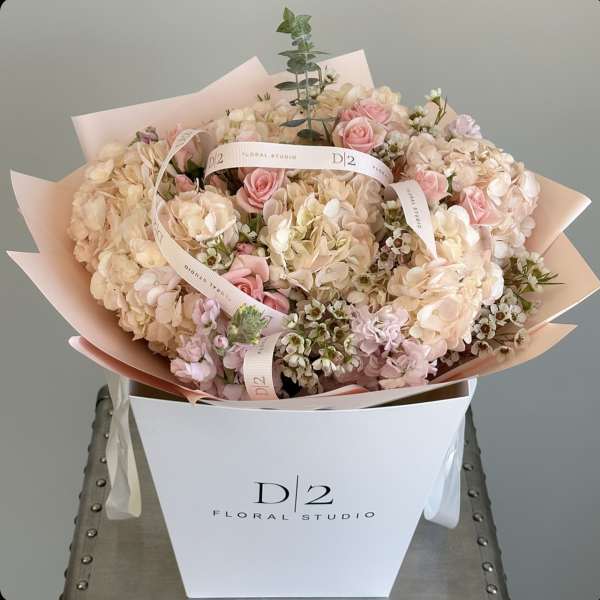 Blush pink and cream bouquet in a white box with ribbon