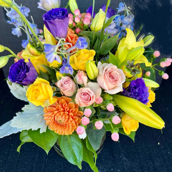 Colorful mixed bouquet with roses, lilies, and dahlias