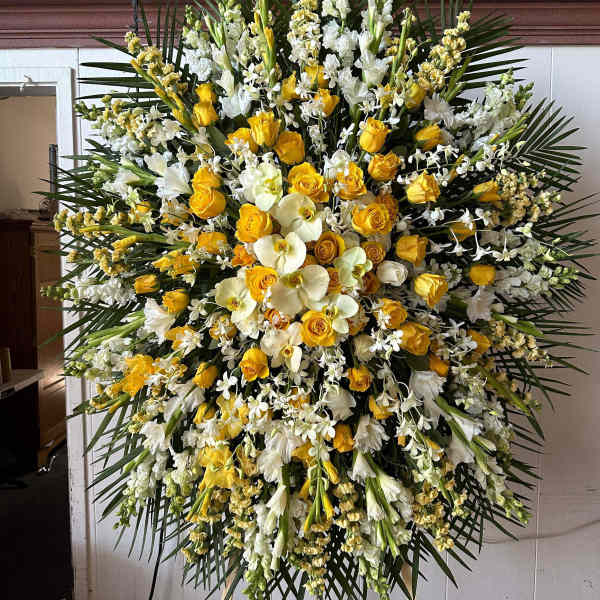 Large standing floral spray with yellow roses and white orchids