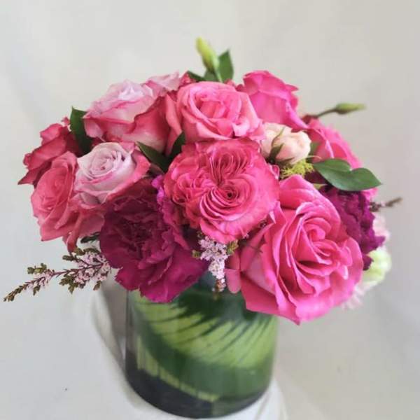 Pink roses arranged in a glass vase