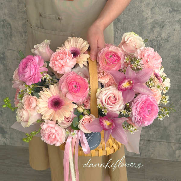 Pink mixed flower basket with roses, gerberas, and orchids