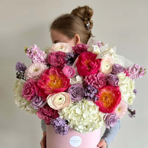 Large pink and lavender bouquet in a round pink box
