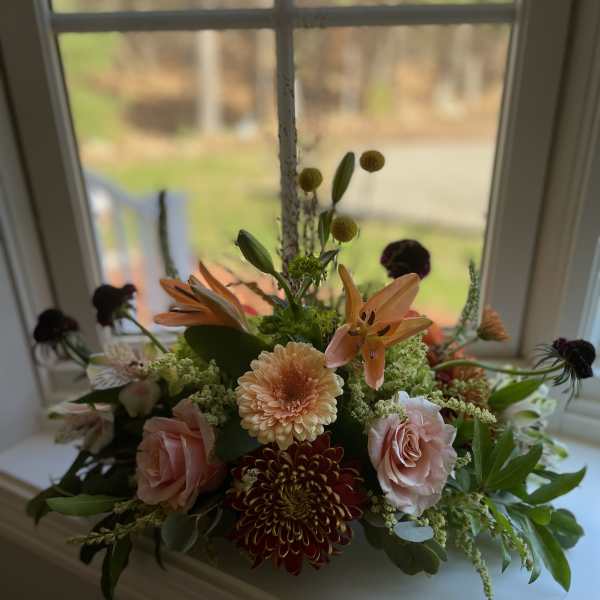 Mixed floral arrangement with pink roses, lilies, and chrysanthemums