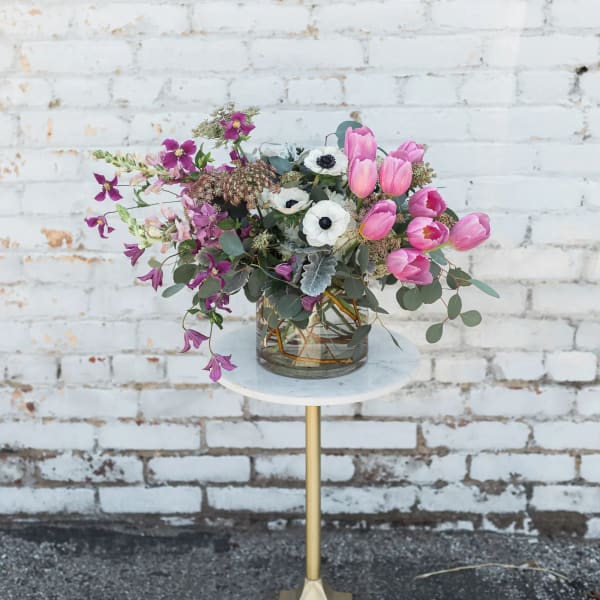 Pink tulips and white anemones in a glass vase