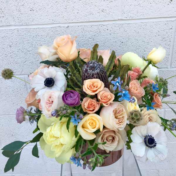 Mixed bouquet of roses and anemones in a vase