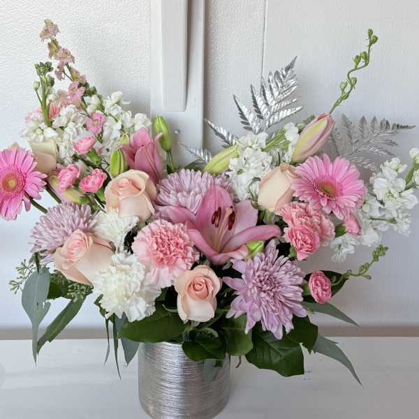 Pink and white mixed flower arrangement in a silver vase