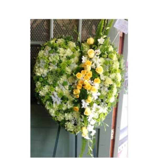 Heart-shaped floral wreath with yellow and white flowers