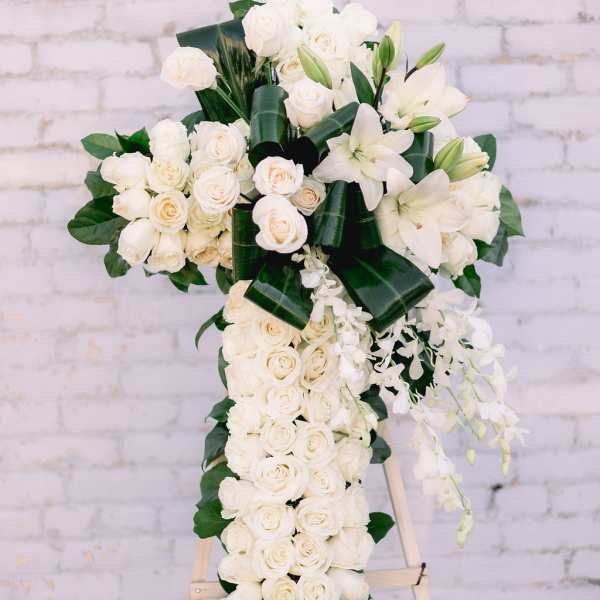 White rose and lily standing spray on an easel