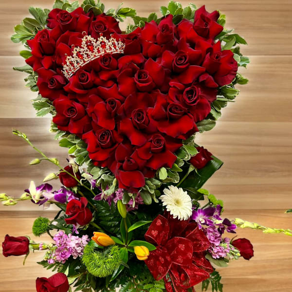 Heart-shaped bouquet of red roses with a jeweled tiara and ribbon