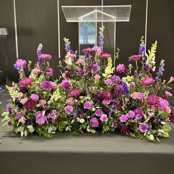 Large purple and pink floral arrangement on a table
