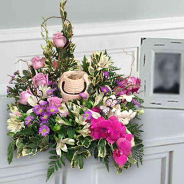 Pink and white floral arrangement with a small basket centerpiece