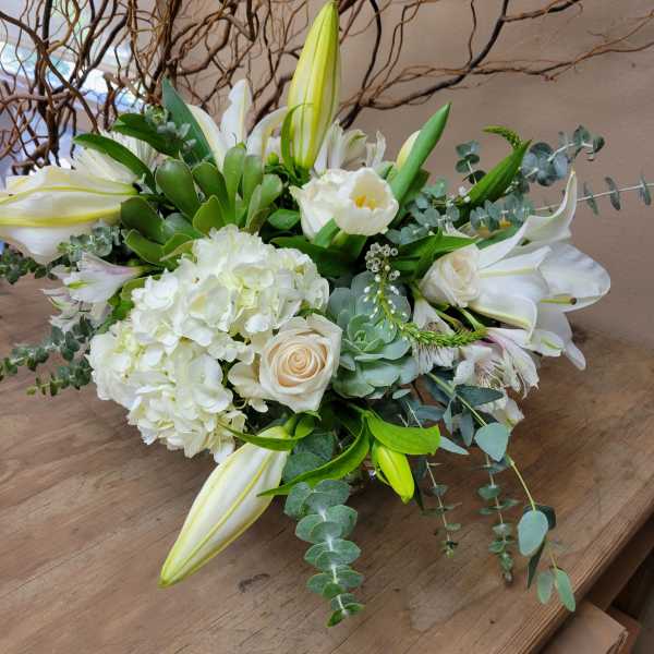 White floral bouquet with lilies, roses, and hydrangeas