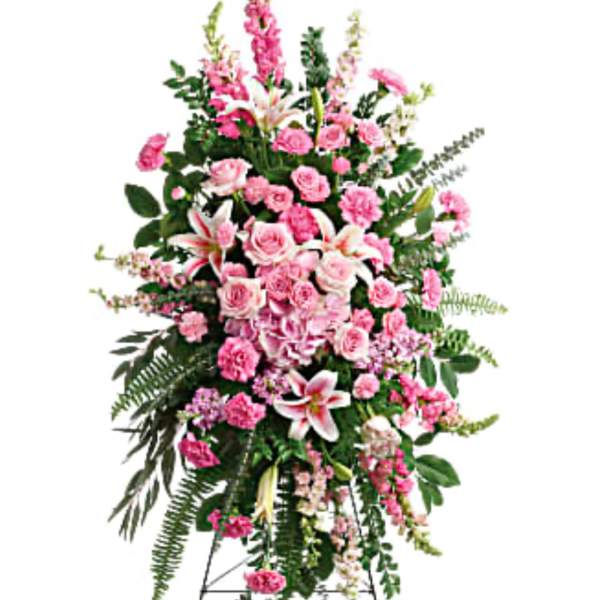 Tall pink and white funeral spray on a stand