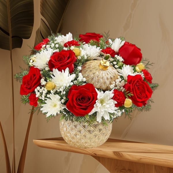Red roses and white daisies in a gold vase