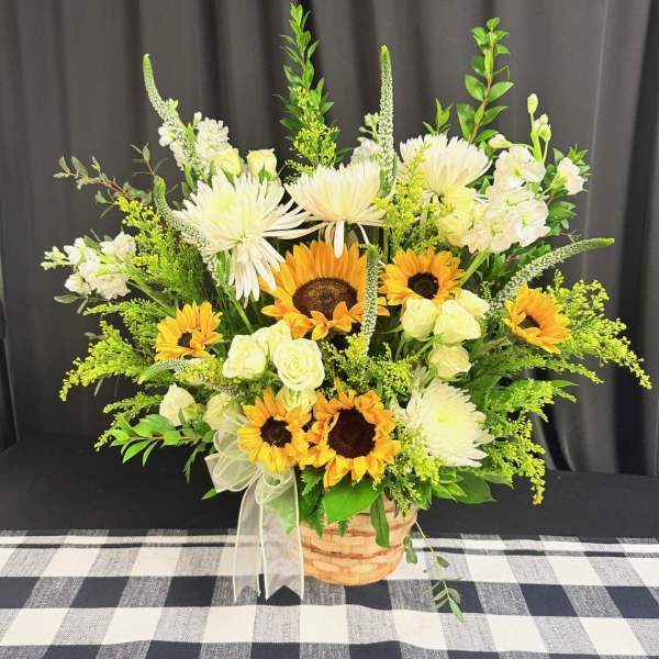 Basket arrangement of sunflowers, white roses, and white daisies