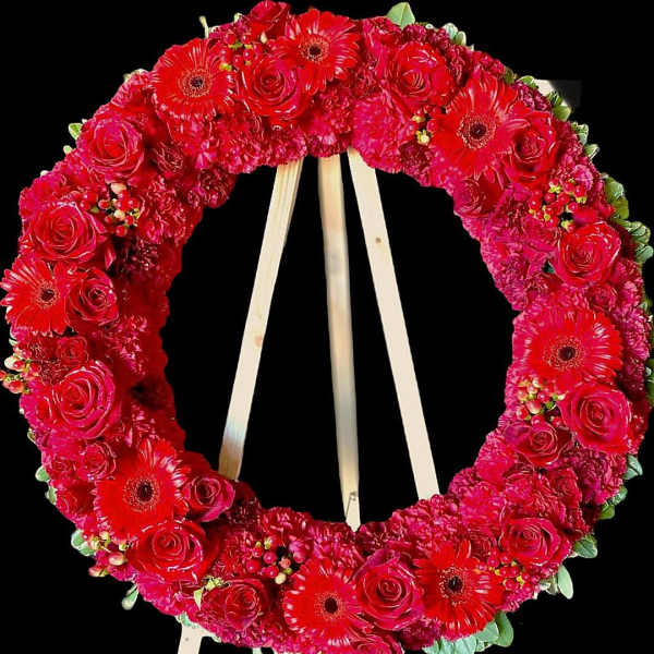 Red floral wreath on a wooden easel