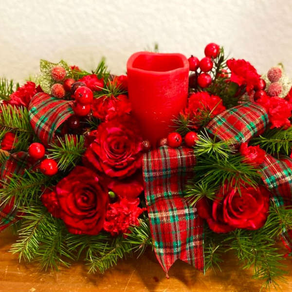 Red rose centerpiece with plaid ribbon and a red candle