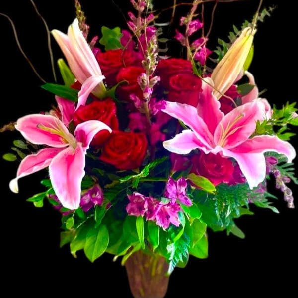 Pink lilies and red roses in a vase