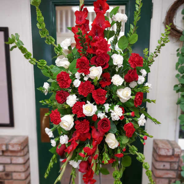 Tall red and white floral standing spray with roses and carnations