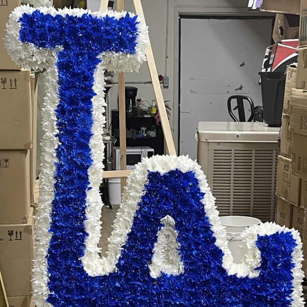 Blue and white floral letter display on a stand