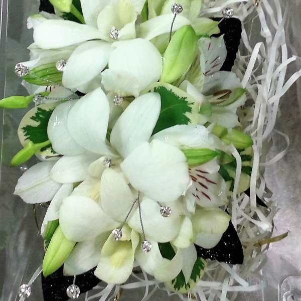 White lily bouquet with green buds and ribbon streamers