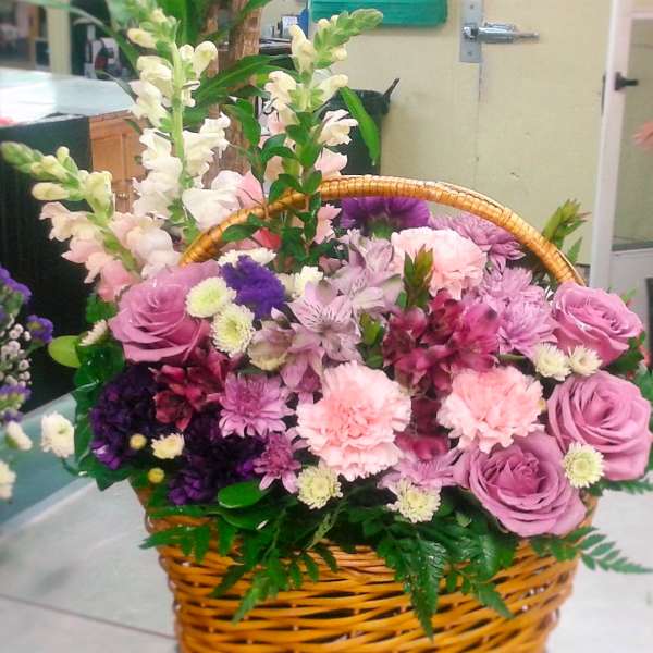 Basket of pink and purple flowers with tall white blooms