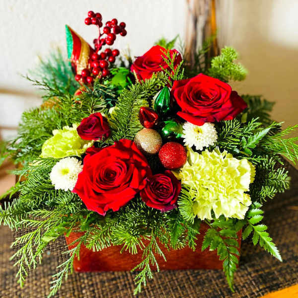 Red roses and white flowers in a festive holiday arrangement